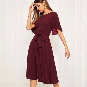 A deep red dress with slit flounce sleeves.
